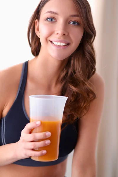 Portrait of a pretty woman holding glass with tasty juice — Stock Photo, Image