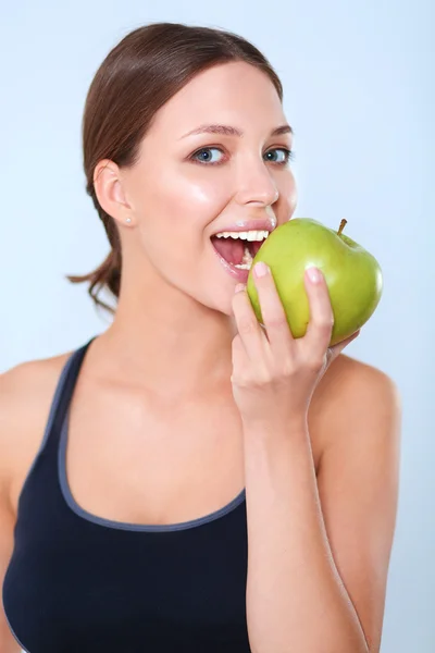 Happy young woman eating apples, isolated on white background Royalty Free Stock Images