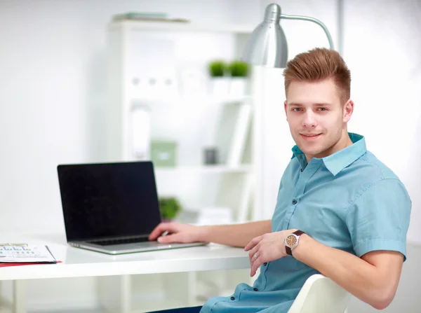 Young businessman working in office, sitting at desk — Stock Photo, Image