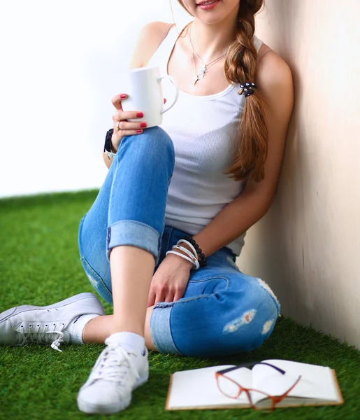 本の芝生の上で座っていた若い女性 — ストック写真