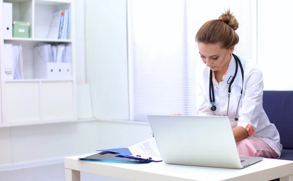 Closeup portrait of a young doctor sitting on the sofa — Stock Photo, Image