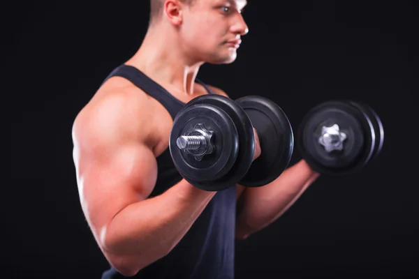 Handsome muscular man working out with dumbbells Royalty Free Stock Images