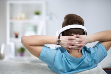 Adam evde kulaklık ile müzik dinleme