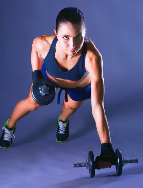 Young woman doing exercise with dumbbells — Stock Photo, Image