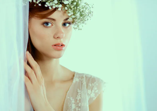 Portrait of a beautiful woman with flowers in her hair — Stock Photo, Image