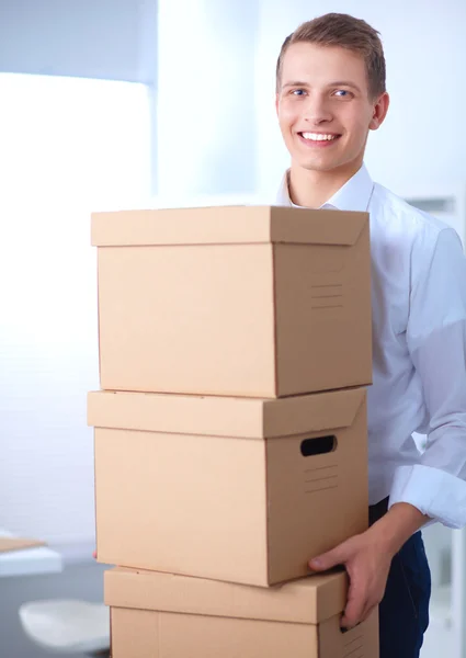 Portrait of a person with moving box and other stuff isolated on white — Stock Photo, Image