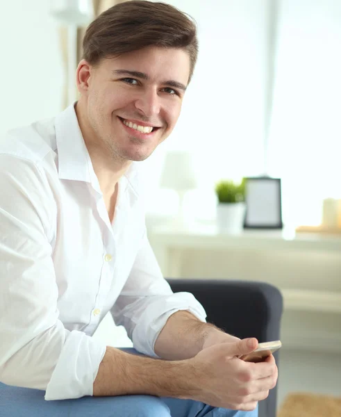 Young businessman working in office, sitting at desk — Stock Photo, Image