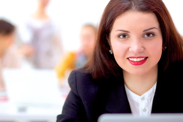 Attractive businesswoman sitting  on desk in the office Royalty Free Stock Photos