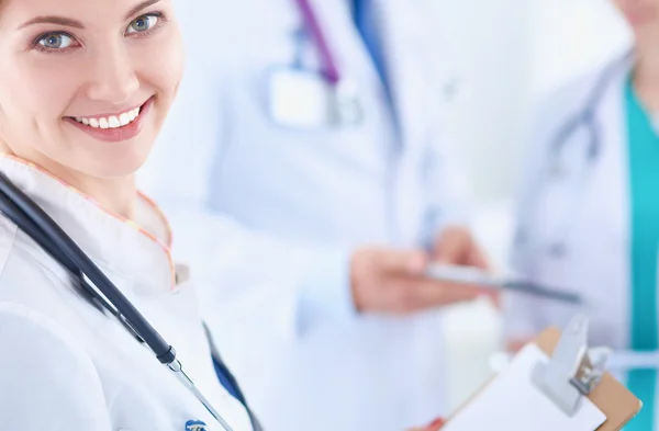 Attractive female doctor in front of medical group Royalty Free Stock Photos