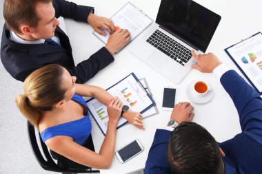 İş adamları iş toplantısında, ofiste oturup tartışıyorlar.