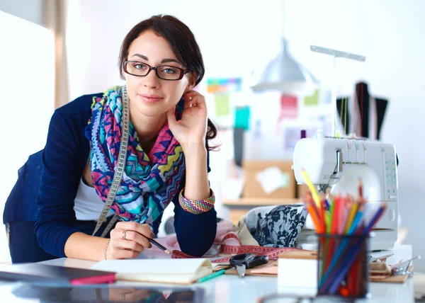 Dressmaker designing clothes pattern on paper — Stock Photo, Image