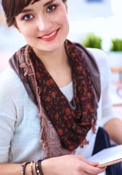 Modern young fashion designer with cup at studio — Stock Photo, Image