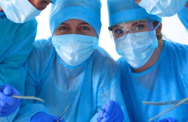 Young surgery team in the operating room clipart