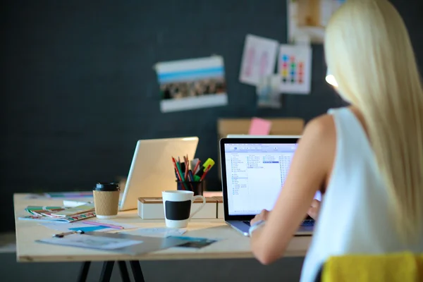 Créateurs de mode travaillant en studio assis sur le bureau — Photo