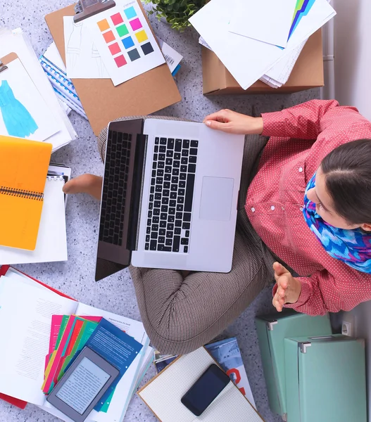 Joven y atractiva diseñadora de moda femenina trabajando en el escritorio de la oficina, dibujando mientras habla en el móvil — Foto de Stock