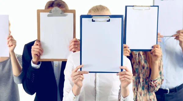 Team of businesspeople holding a folders near face isolated on white background — Stock Photo, Image