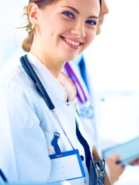 Attractive female doctor in front of medical group — Stock Photo, Image