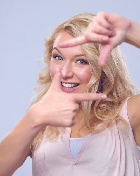 Young woman creating a frame with fingers — Stock Photo, Image