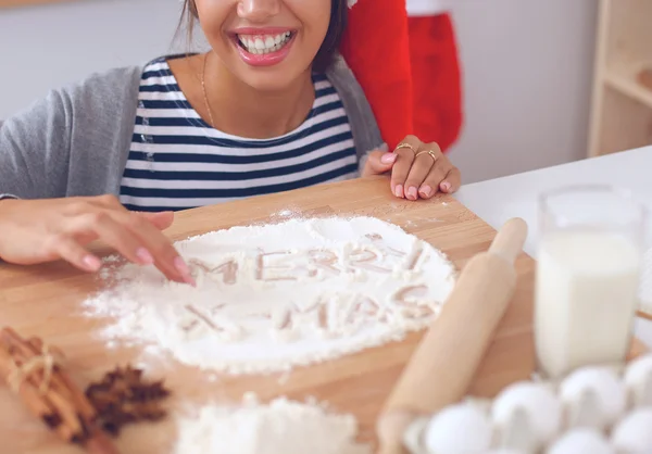 Kadın mutfakta Noel kurabiyesi yapıyor. — Stok fotoğraf