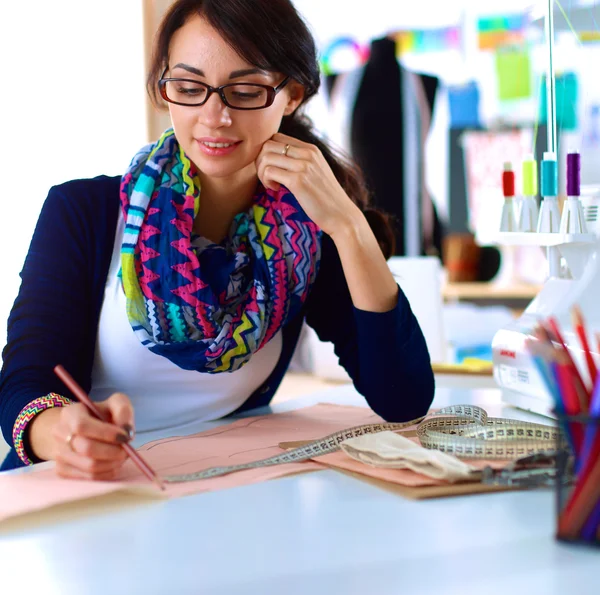 Dressmaker designing clothes pattern on paper — Stock Photo, Image