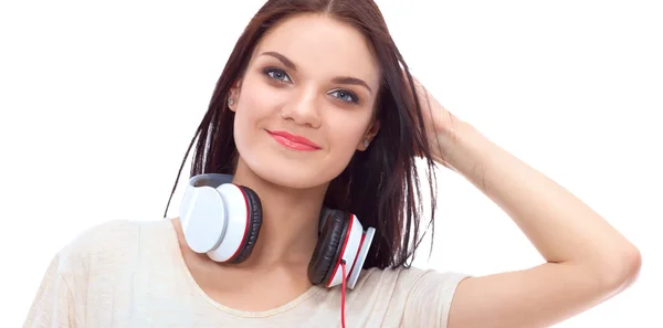 Smiling girl with headphones sitting on the floor near wall — Stock Photo, Image