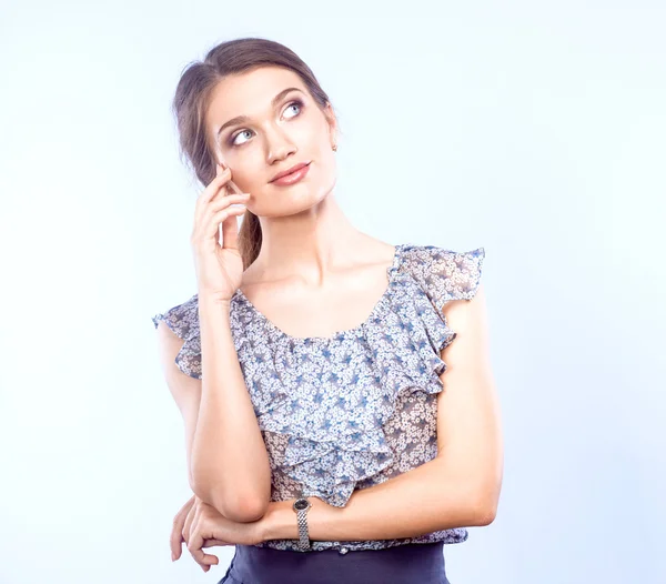 Young woman holding a laptop, standing on gray background — Stock Photo, Image