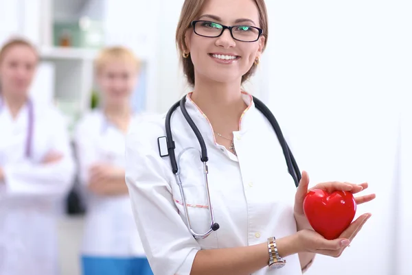 Doctor with stethoscope holding heart, isolated on white  background — Stock Photo, Image
