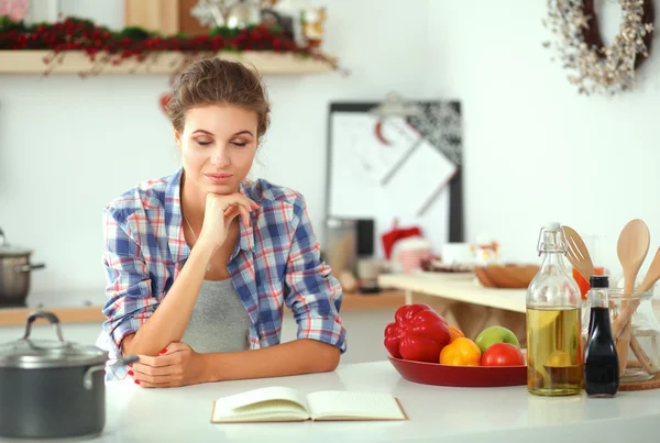Jovem mulher ler revista Na cozinha em casa — Fotografia de Stock