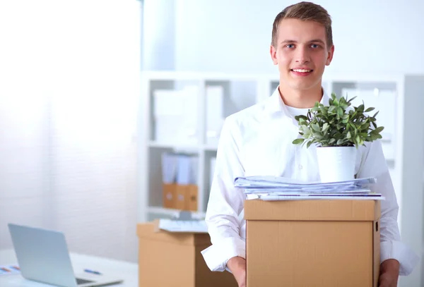 Portrait of a person with moving box and other stuff isolated on white — Stock Photo, Image