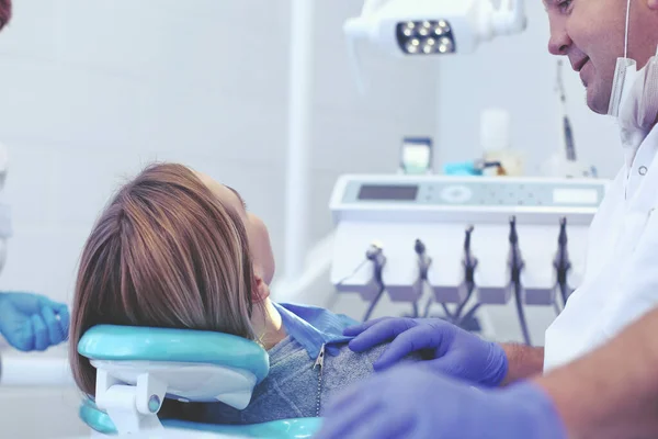 Detail of hand holding dental tools in dental clinic. Dentist Concept