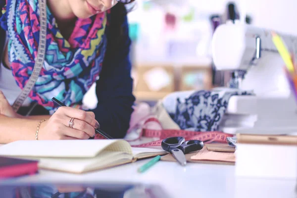 Dressmaker designing clothes pattern on paper — Stock Photo, Image