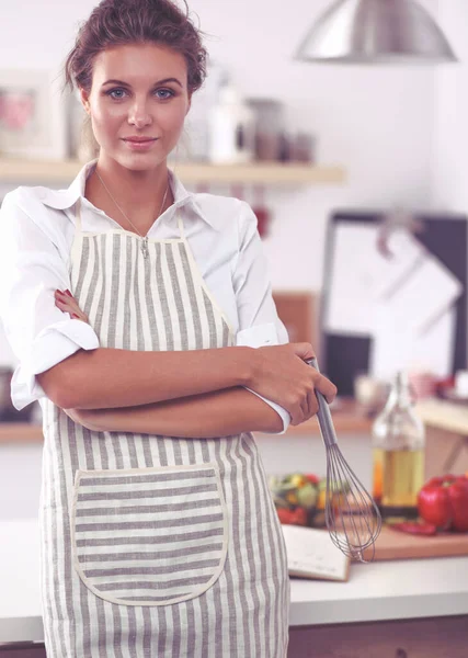 Žena s korolou stojící v kuchyni — Stock fotografie