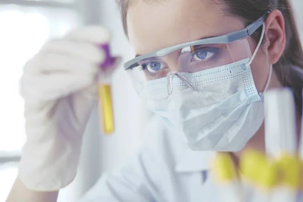 Researcher, doctor, scientist or laboratory assistant working with plastic medical tubes in modern lab or hospital — Stock Photo, Image