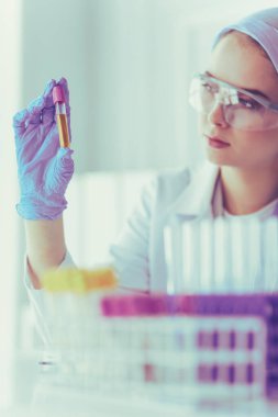 Laboratuvar asistanı bir kan örneğini analiz ediyor.