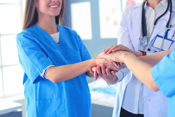 Doctors and nurses in a medical team stacking hands — Stock Photo, Image