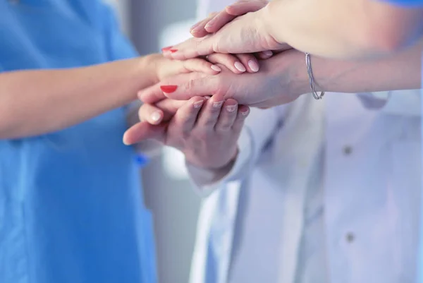 Doctors and nurses in a medical team stacking hands — Stock Photo, Image