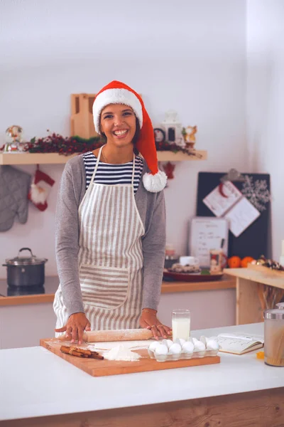 Happy young woman smiling happy having fun with Christmas preparations wearing Santa hat — Stock Photo, Image