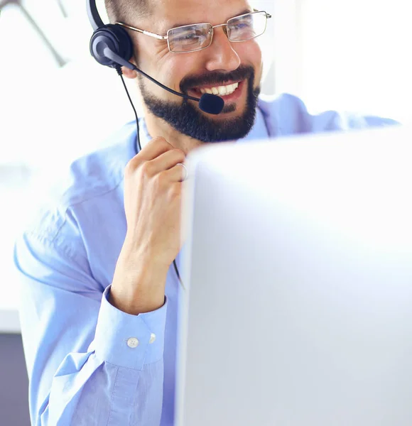 Portrait of a young man with a headset in front of a laptop computer — Stock Photo, Image