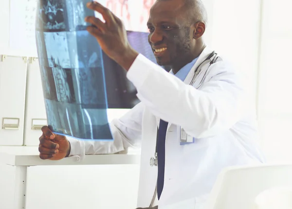 Male black doctor worker with tablet computer standing in hospital