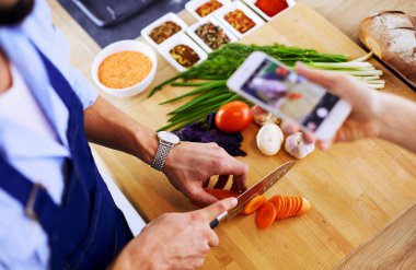 Adam ev mutfağında lezzetli ve sağlıklı yemekler hazırlıyor.