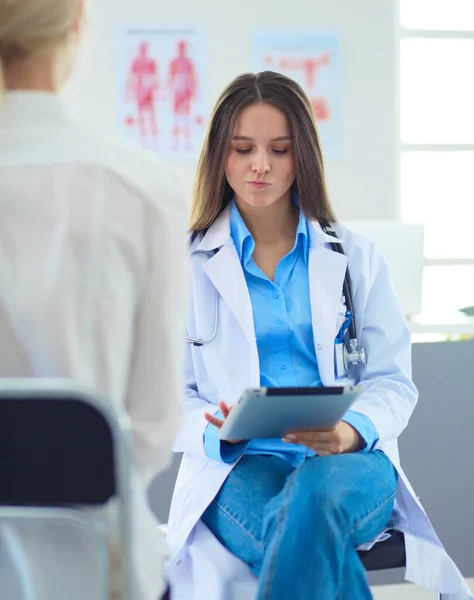 Doctor y paciente discutiendo algo mientras están sentados en la mesa. Concepto de medicina y salud — Foto de Stock