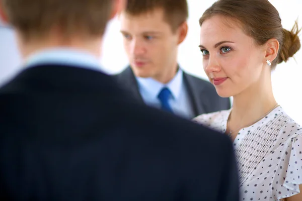 Businesswoman writing on flipchart while giving presentation to colleagues in office — Stock Photo, Image