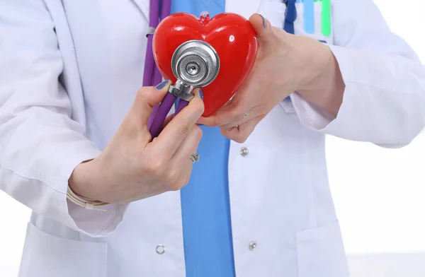 Young woman doctor holding a red heart, isolated on white background. Woman doctor — Stock Photo, Image