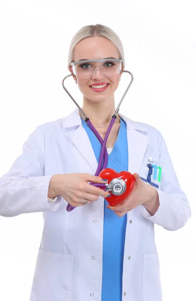 Young woman doctor holding a red heart, isolated on white background. Woman doctor — Stock Photo, Image