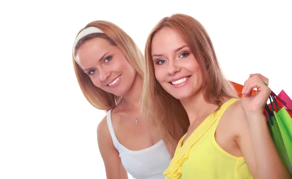 Mulheres felizes com sacos de compras isolados no fundo branco — Fotografia de Stock