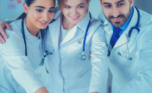 Successful medical team. Confident doctors team standing together and smiling