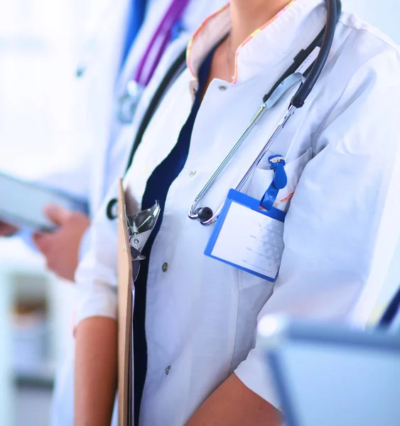 Woman doctor standing at hospital witih folder — Stock Photo, Image