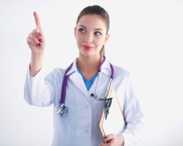 Woman doctor standing with folder at hospital and pointing up