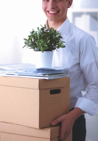 Portrait of a person with moving box and other stuff isolated on white — Stock Photo, Image