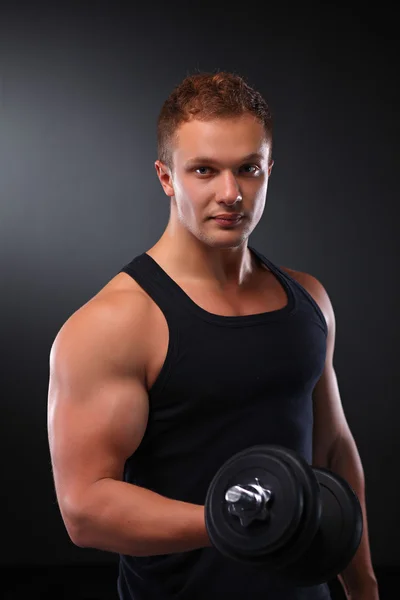 Fit muscular man exercising with dumbbell — Stock Photo, Image